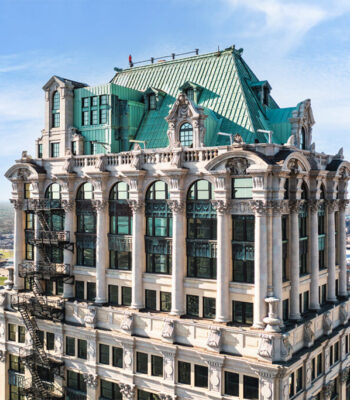 kraemer-design-group-kdg-detroit-book-tower-exterior-drone-shot-building-architecture-historical-close-windows-green-copper-roof-header