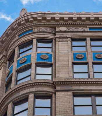 kraemer-design-group-kdg-detroit-exterior-building-close-up-blue-rosettes-windows-header