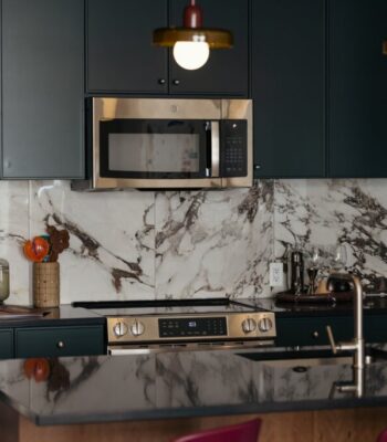 kraemer-design-group-kdg-detroit-the-belle-interior-kitchen-green-cabinetry-black-counterop